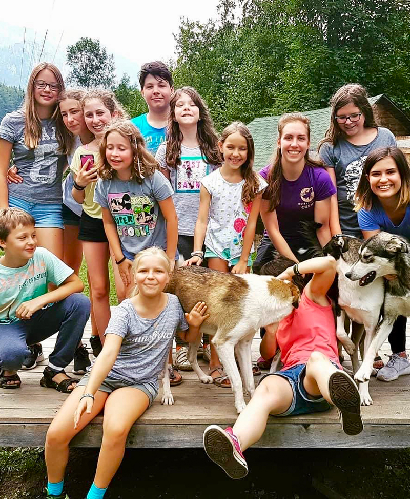 Huskyfieber Bild mit Kindern und Huskys die am Feriencamp Angebot teilgenommen haben